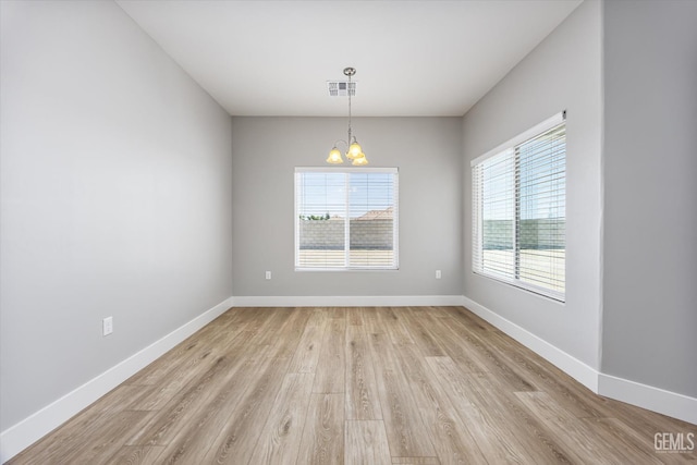 205 Goertzen Ave, Shafter, CA 93263 - unfurnished room with light wood-style floors and a chandelier