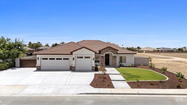 205 Goertzen Ave, Shafter, CA 93263 - view of front of property featuring stone siding, a garage, concrete driveway, and stucco siding