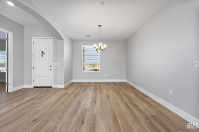 205 Goertzen Ave, Shafter, CA 93263 - entrance foyer featuring arched walkways, healthy amount of natural light, light wood finished floors, and a chandelier