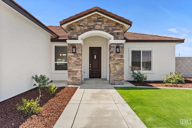 205 Goertzen Ave, Shafter, CA 93263 - doorway to property with stone siding, stucco siding, and a tile roof