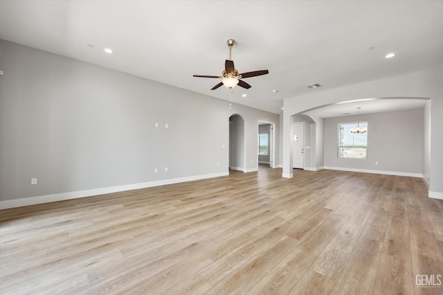 205 Goertzen Ave, Shafter, CA 93263 - unfurnished living room featuring a ceiling fan, arched walkways, light wood-style flooring, recessed lighting, and a chandelier
