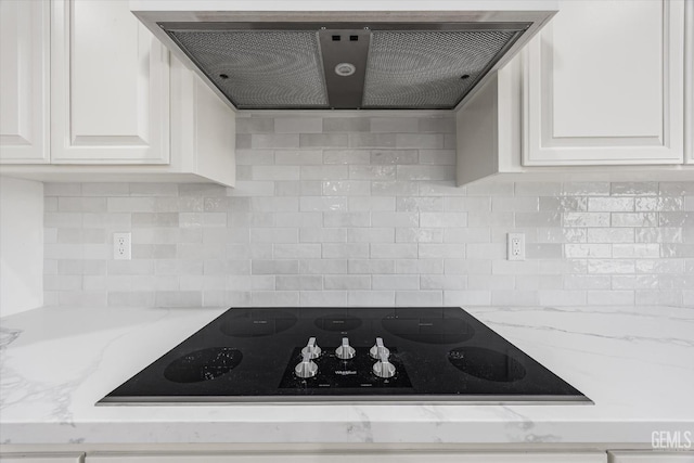 205 Goertzen Ave, Shafter, CA 93263 - kitchen with extractor fan, black electric stovetop, white cabinetry, and tasteful backsplash