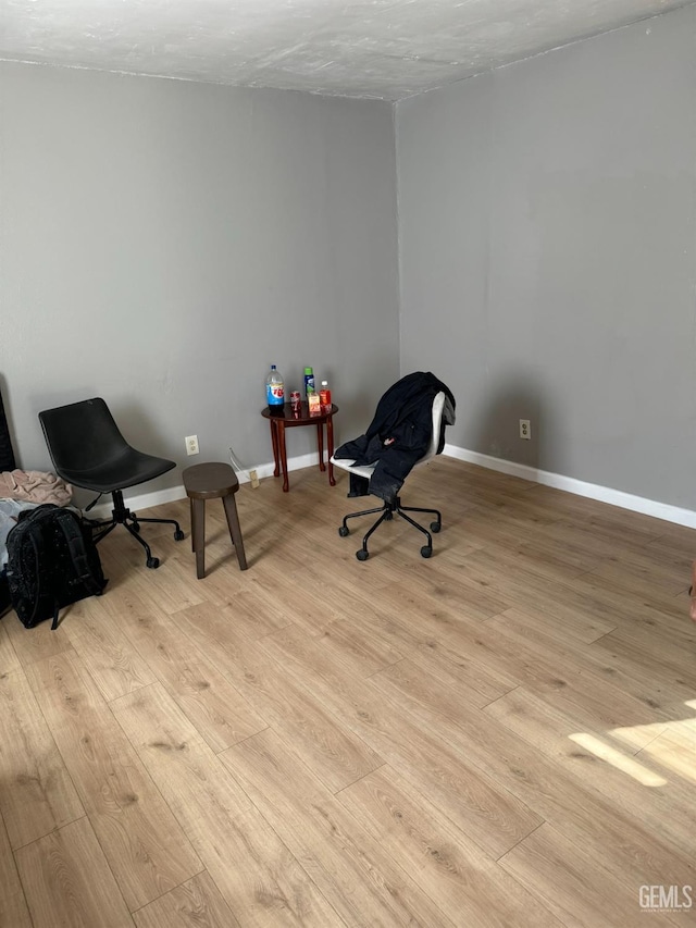 sitting room featuring a textured ceiling and light hardwood / wood-style floors