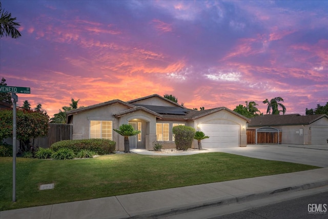 5502 Veneto St, Bakersfield, CA 93308 - ranch-style home with driveway, an attached garage, roof mounted solar panels, and stucco siding