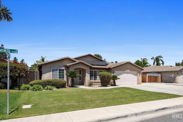 5502 Veneto St, Bakersfield, CA 93308 - single story home with concrete driveway, a garage, roof mounted solar panels, and stucco siding