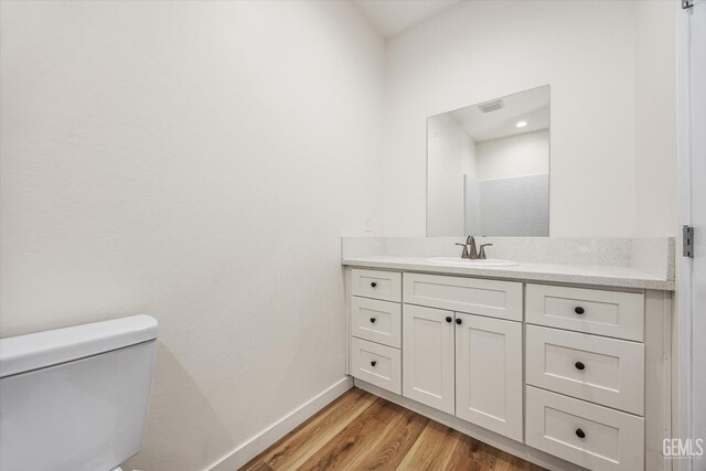 135 L St, Bakersfield, CA 93304 - bathroom with vanity and wood finished floors