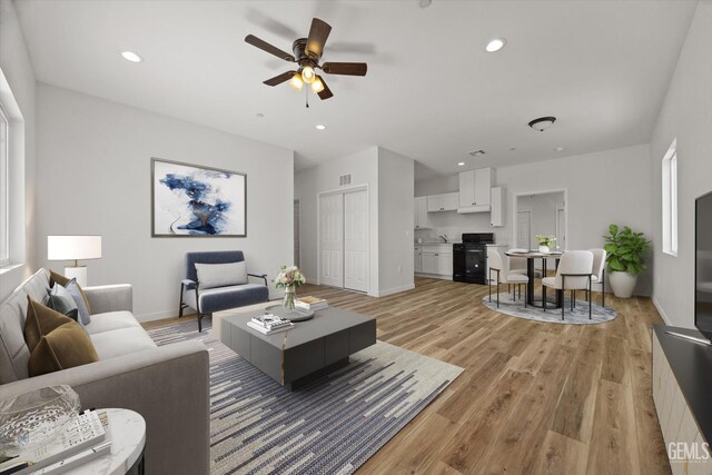 135 L St, Bakersfield, CA 93304 - living room with light wood-style floors, a ceiling fan, and recessed lighting
