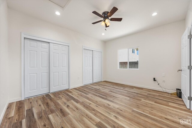 135 L St, Bakersfield, CA 93304 - unfurnished bedroom featuring two closets, light wood finished floors, recessed lighting, and a ceiling fan