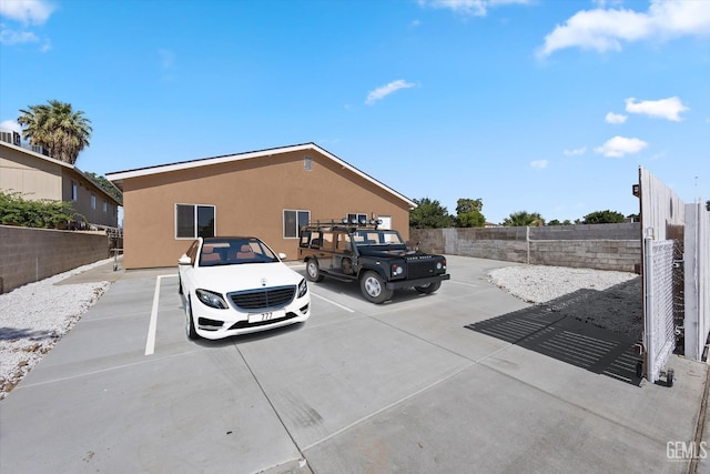 135 L St, Bakersfield, CA 93304 - uncovered parking lot featuring a fenced backyard
