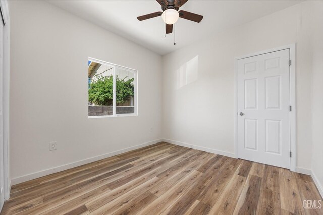 135 L St, Bakersfield, CA 93304 - unfurnished bedroom with light wood-type flooring and a ceiling fan
