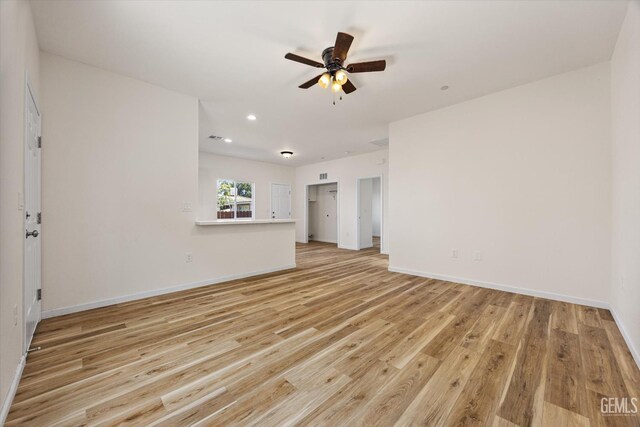 135 L St, Bakersfield, CA 93304 - unfurnished living room featuring light wood-style flooring, a ceiling fan, and recessed lighting