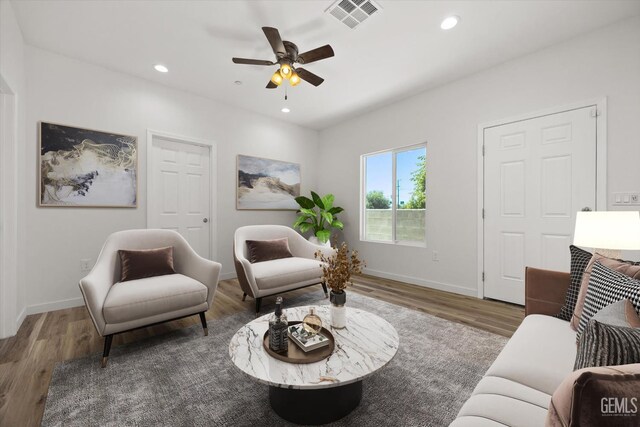 135 L St, Bakersfield, CA 93304 - living area with wood finished floors, ceiling fan, and recessed lighting
