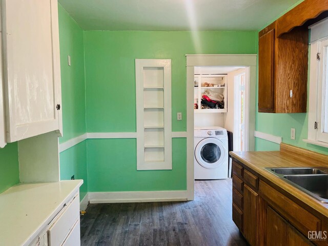 323 A St, Bakersfield, CA 93304 - laundry area with washer / dryer, a sink, dark wood-type flooring, and baseboards