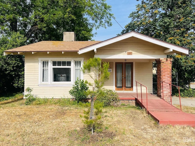 323 A St, Bakersfield, CA 93304 - bungalow-style house featuring covered porch and a chimney