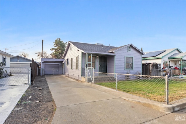 view of front of house featuring a garage, an outdoor structure, and a front yard