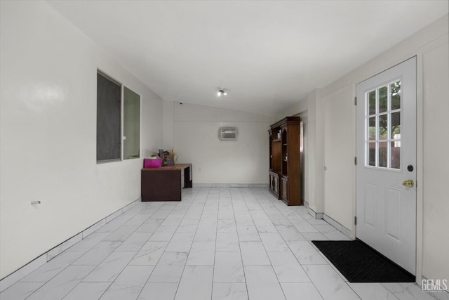 unfurnished room with marble finish floor, a wall mounted air conditioner, and lofted ceiling