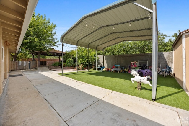 view of parking / parking lot with a fenced backyard and a detached carport