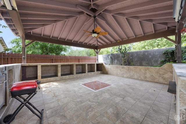 view of patio featuring fence and ceiling fan