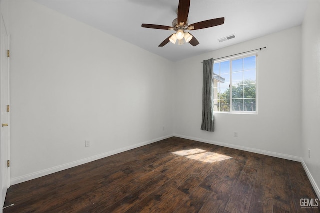 spare room with wood-type flooring, baseboards, ceiling fan, and visible vents