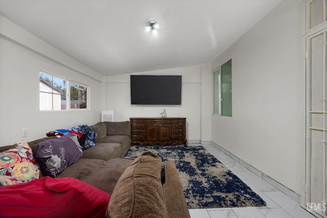 living room featuring marble finish floor and lofted ceiling