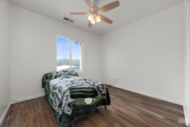 bedroom featuring baseboards, ceiling fan, wood finished floors, and visible vents