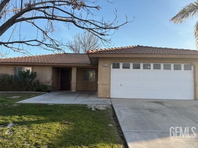 ranch-style house with a garage, a front yard, and stucco siding