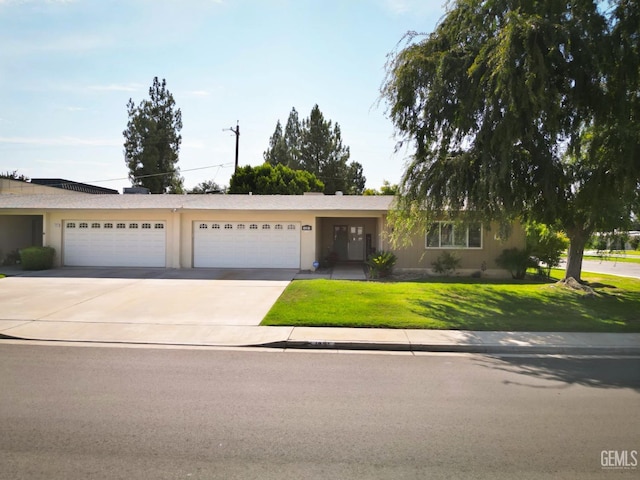 ranch-style home featuring a garage and a front yard