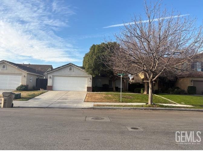 single story home with a garage and a front yard