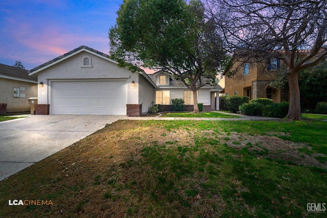 view of front of home with brick siding, stucco siding, a lawn, an attached garage, and driveway