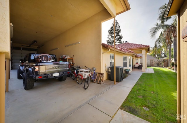 exterior space featuring central AC and fence