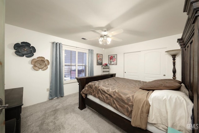 bedroom with carpet floors, a closet, visible vents, and a ceiling fan