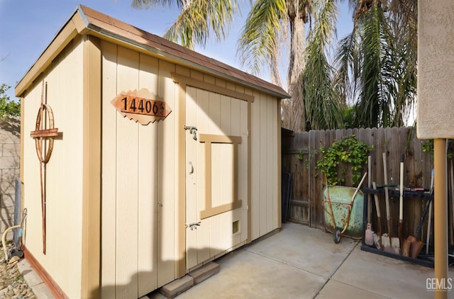 view of shed with fence