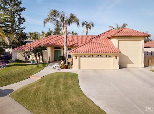 mediterranean / spanish-style house featuring a garage, driveway, a tiled roof, a front lawn, and stucco siding