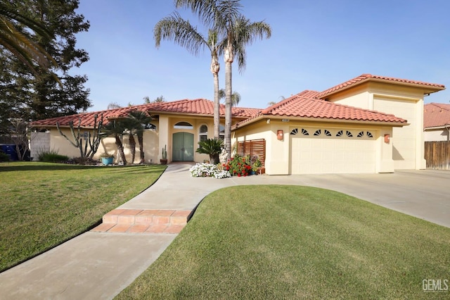 mediterranean / spanish house with a garage, driveway, a tile roof, a front lawn, and stucco siding