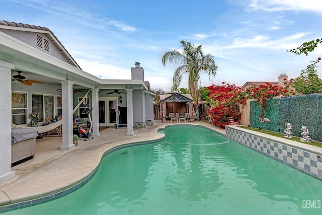 view of pool with a ceiling fan, a patio area, a gazebo, a fenced in pool, and a fenced backyard
