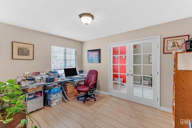 office with baseboards, french doors, and light wood finished floors