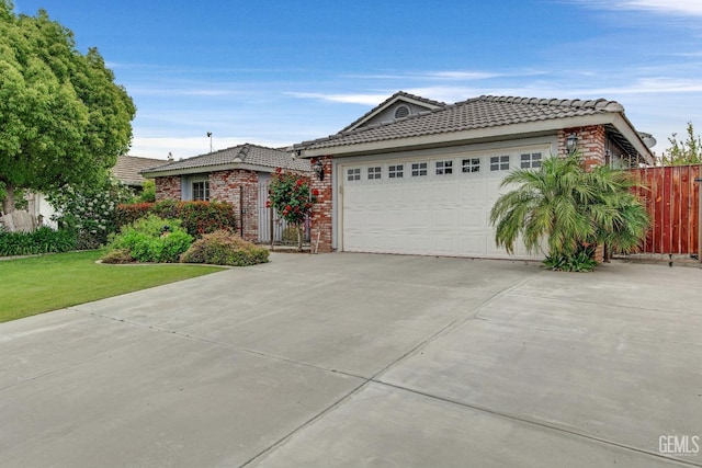 single story home with a tiled roof, brick siding, fence, concrete driveway, and an attached garage