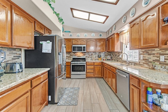 kitchen with backsplash, open shelves, vaulted ceiling, a sink, and stainless steel appliances