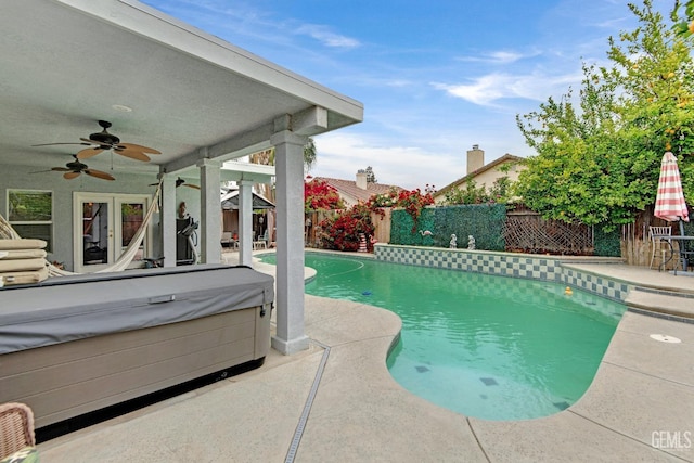 view of pool with a fenced backyard, a ceiling fan, a patio, and a hot tub