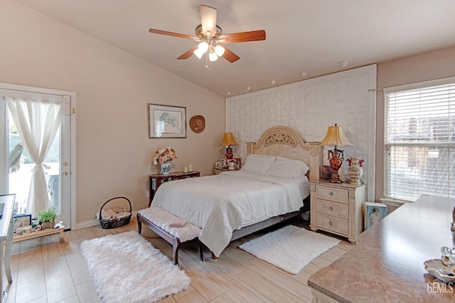 bedroom featuring ceiling fan, vaulted ceiling, and light wood-style floors