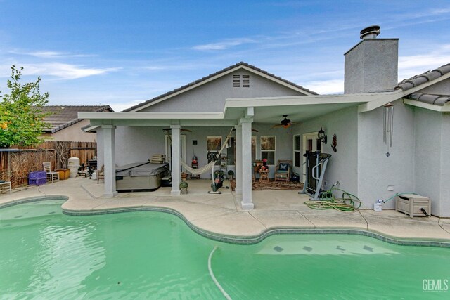 view of pool with a patio, ceiling fan, fence, and a fenced in pool