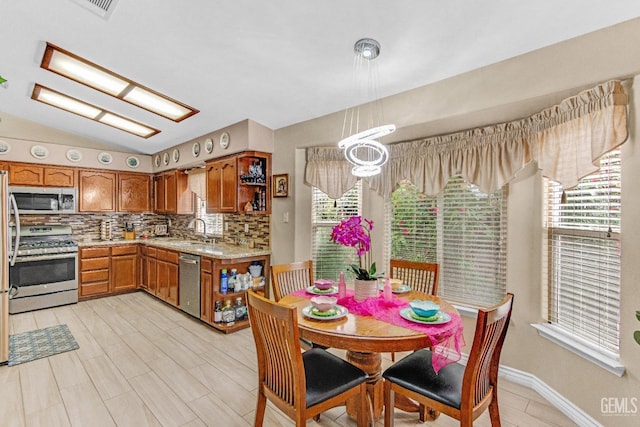 dining space featuring visible vents, plenty of natural light, and lofted ceiling