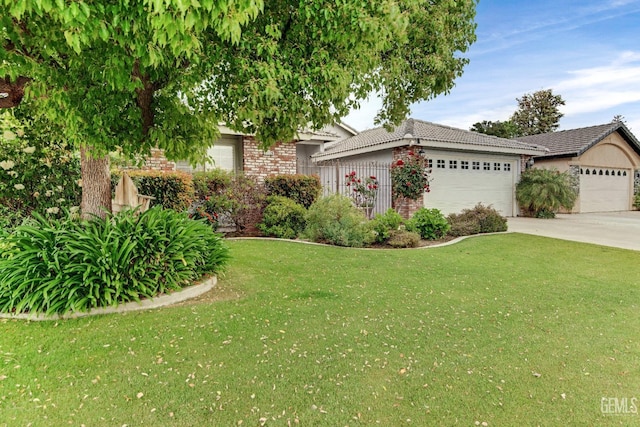 view of front of house featuring a front lawn, brick siding, a tiled roof, an attached garage, and driveway