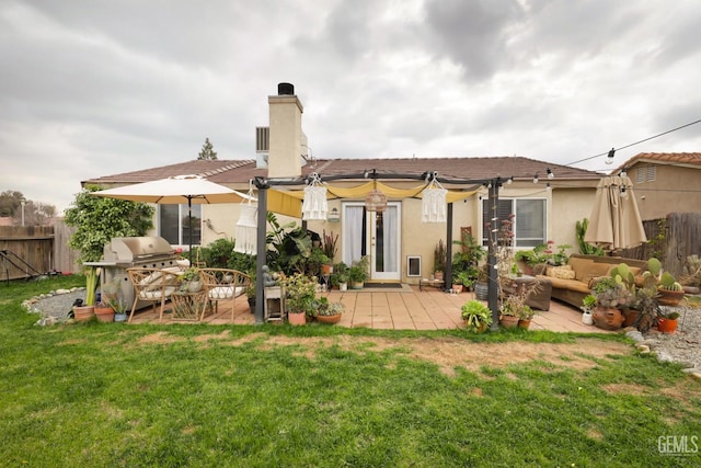 rear view of house featuring a patio area, a yard, and an outdoor living space