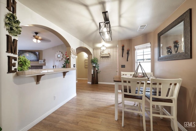 dining room with ceiling fan and wood-type flooring