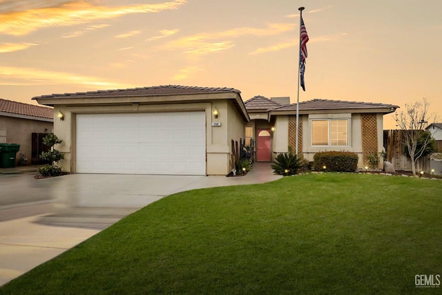 view of front of property featuring a garage and a yard