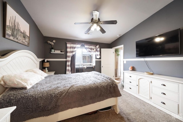 carpeted bedroom with vaulted ceiling and ceiling fan