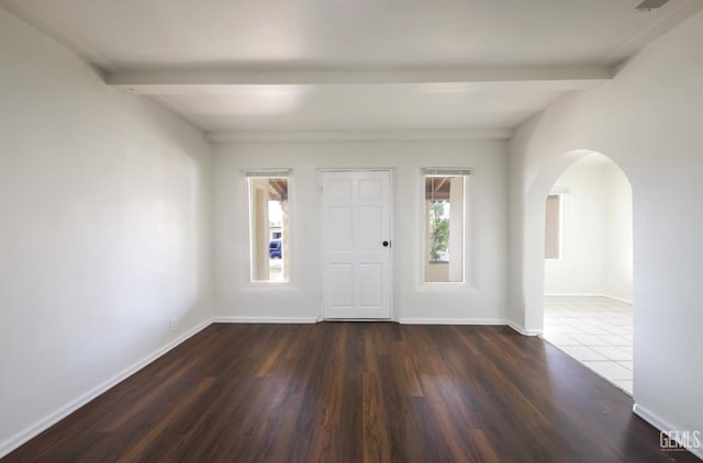 719 Washington Ave, Bakersfield, CA 93308 - foyer featuring plenty of natural light, beamed ceiling, arched walkways, dark wood finished floors, and baseboards