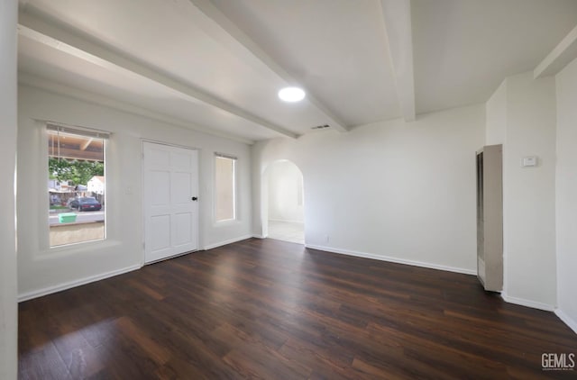 719 Washington Ave, Bakersfield, CA 93308 - unfurnished room with beam ceiling, arched walkways, wood finished floors, and baseboards