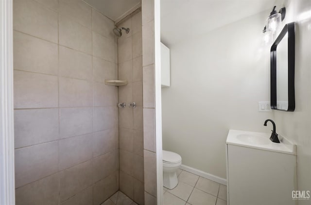 719 Washington Ave, Bakersfield, CA 93308 - bathroom with a tile shower, vanity, toilet, tile patterned floors, and baseboards